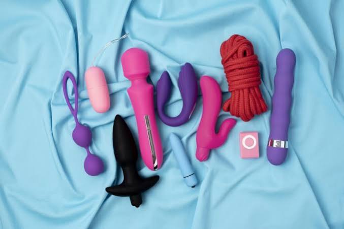 Rechargeable personal massagers laid out on a pale blue cloth